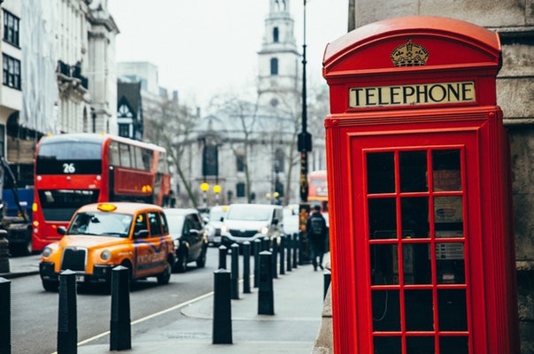 Telephone booth on the street with cars