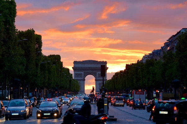 cars and the paris monument as backdrop with the sunseting