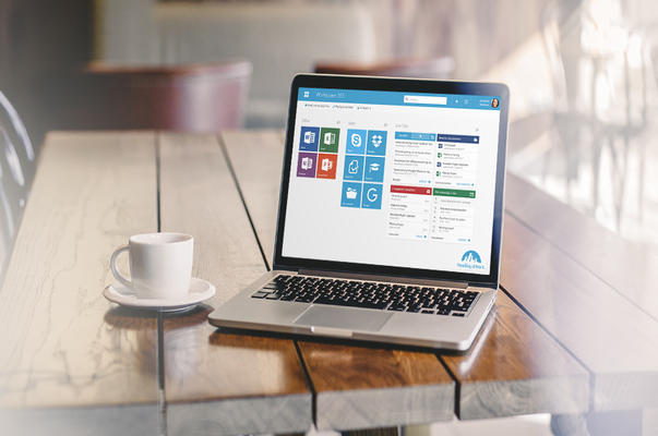 a laptop and tea cup on a table