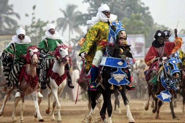 Men on horseback dressed in the native Kano attire