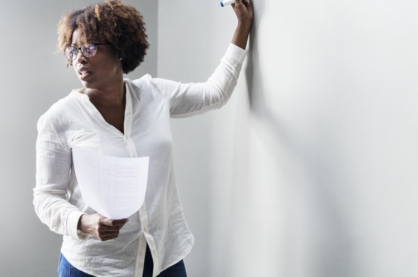 woman at a board explaining